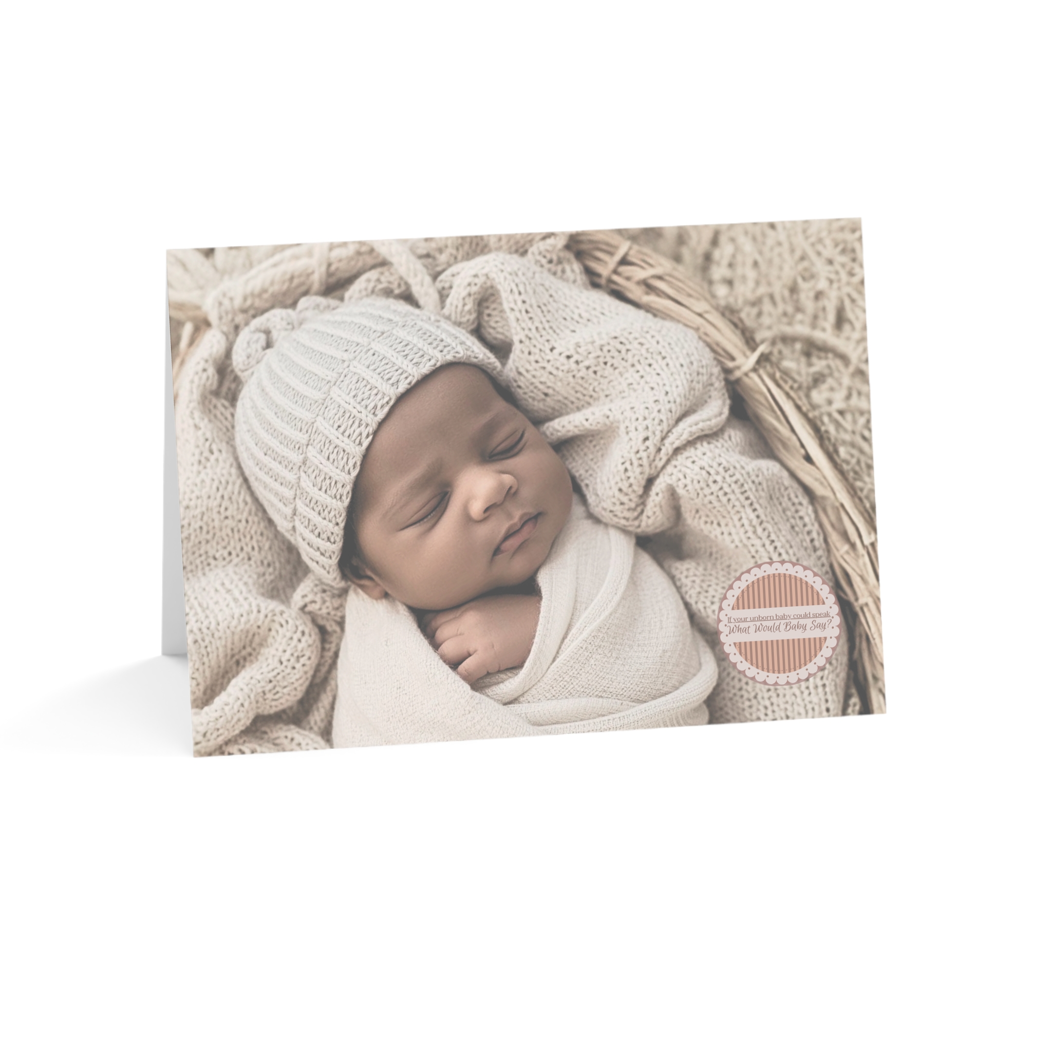 Anytime pregnancy card, with African American appearing baby in a beige blanket with the words “If your unborn baby could speak, what would baby say?” in a medallion on the front of the card. Universal option.