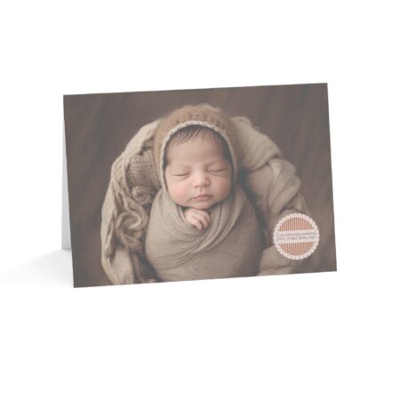 Anytime pregnancy card, with Hispanic appearing baby in a beige blanket with the words “If your unborn baby could speak, what would baby say?” in a medallion on the front of the card. Universal Option.